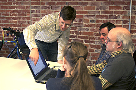 group in front of laptop Icon of storage device